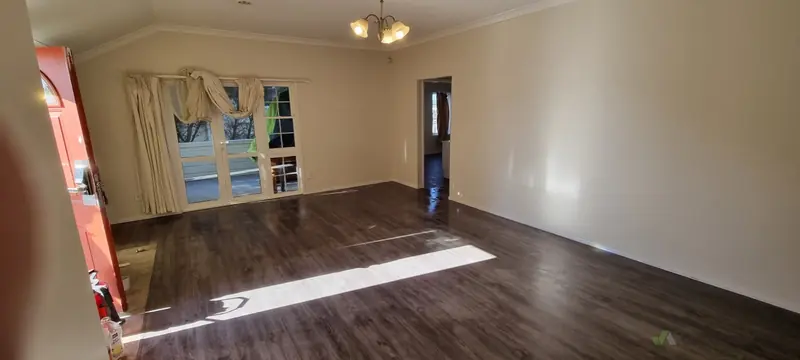 Same room with new dark wood-look laminate flooring