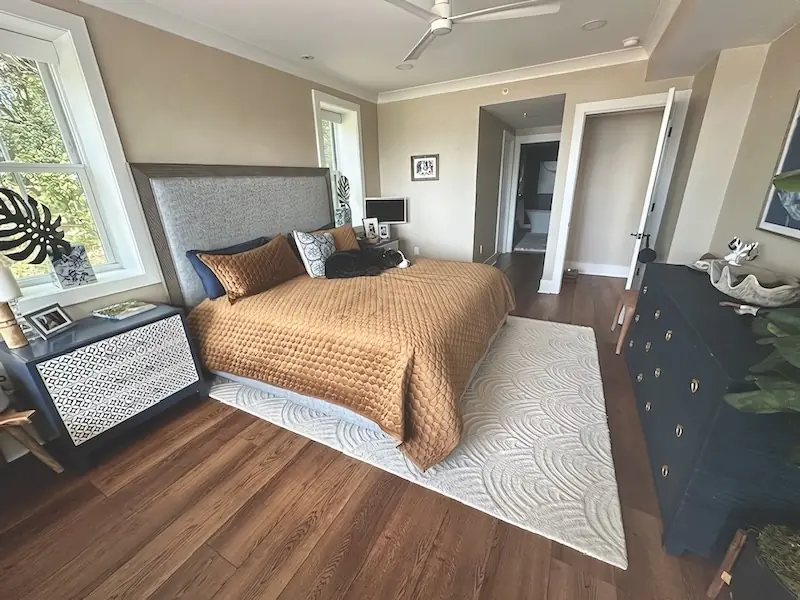 Same bedroom with new warm brown luxury vinyl plank flooring