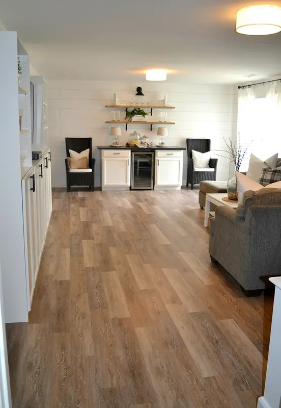 Finished basement rec room with light oak-look luxury vinyl plank flooring